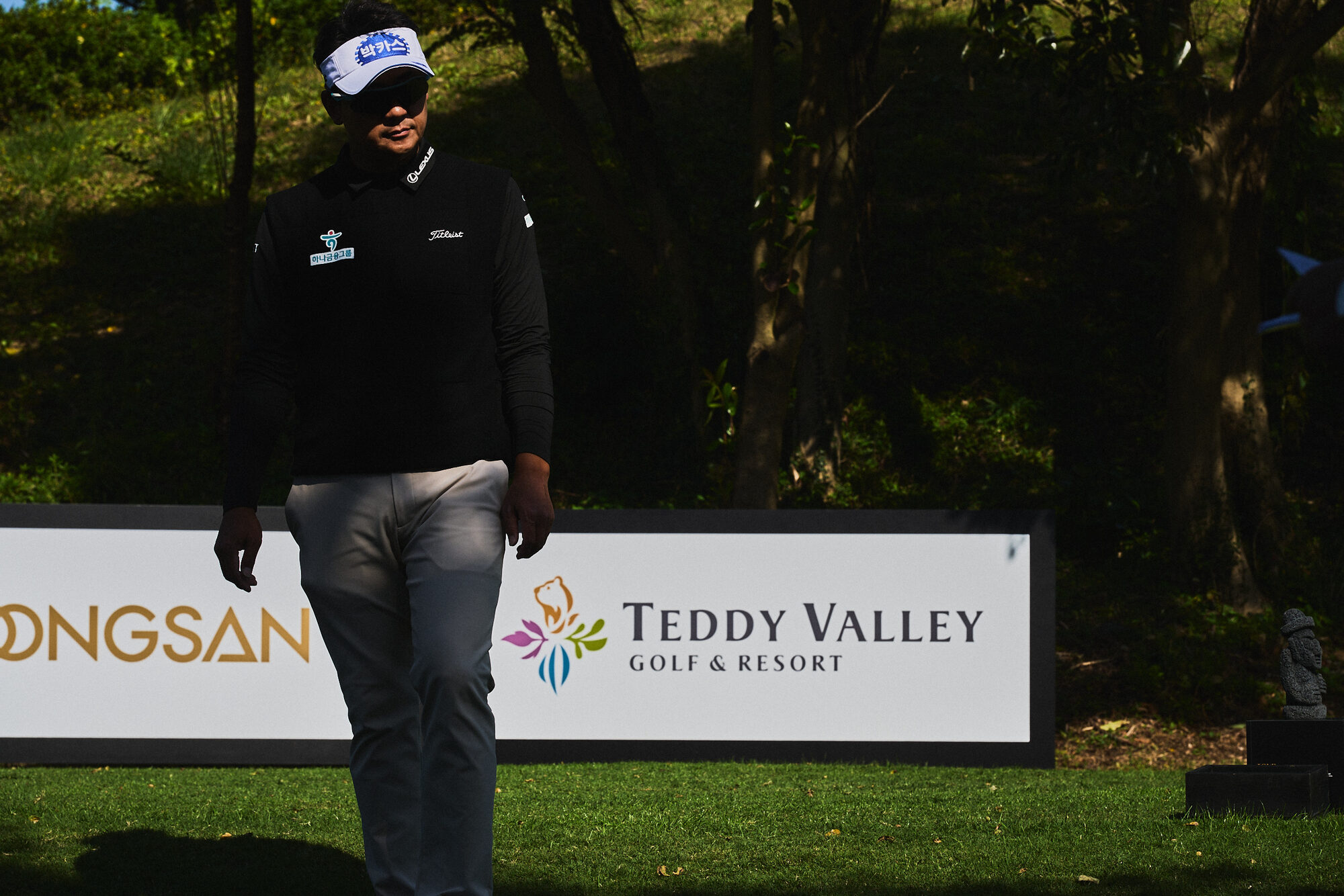 A moving figure and a player on the course during the KPGA event in Jeju. Image 4.