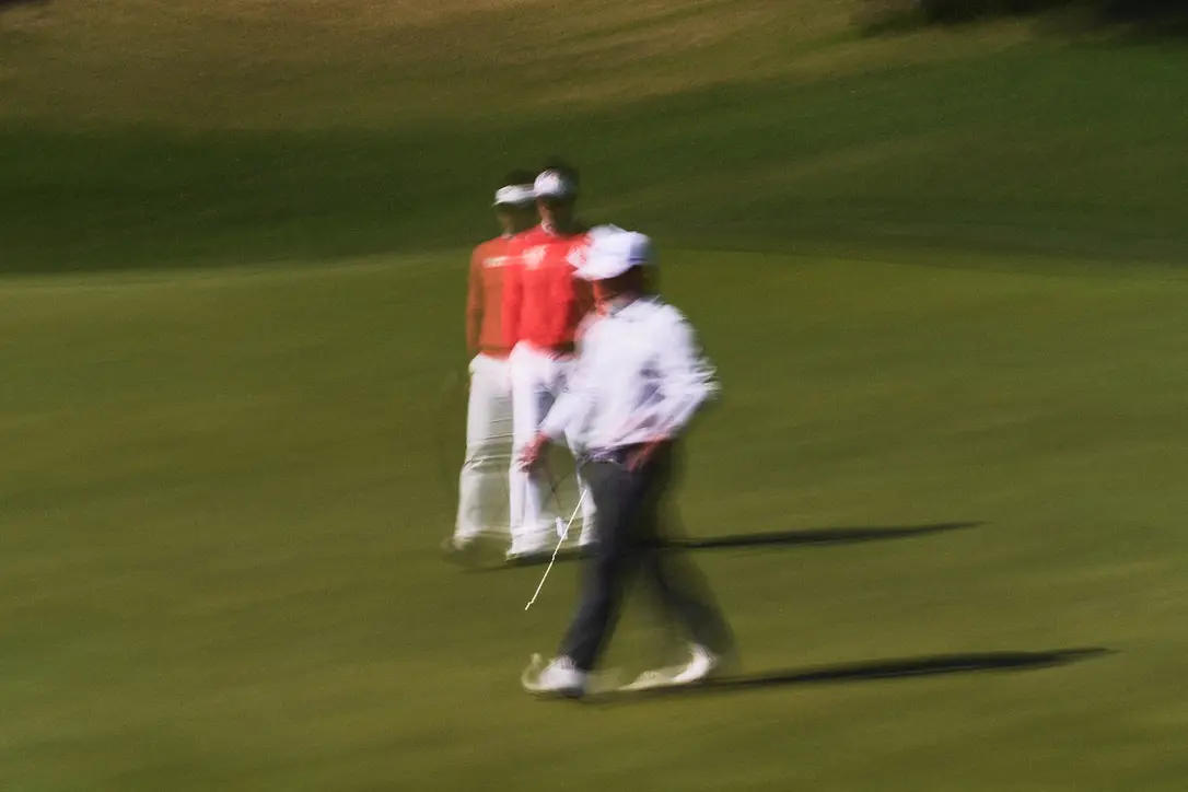 A moving figure and a player on the course during the KPGA event in Jeju. Image 5.
